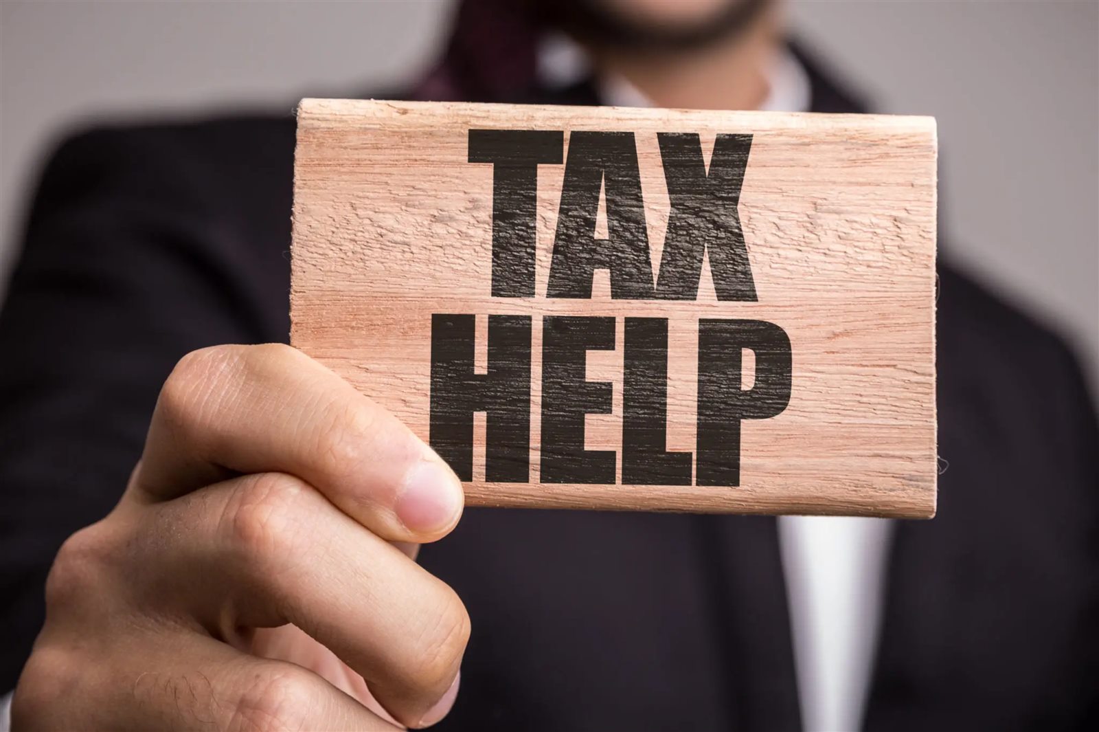 Tax advisor calculating reports and reviewing financial paperwork